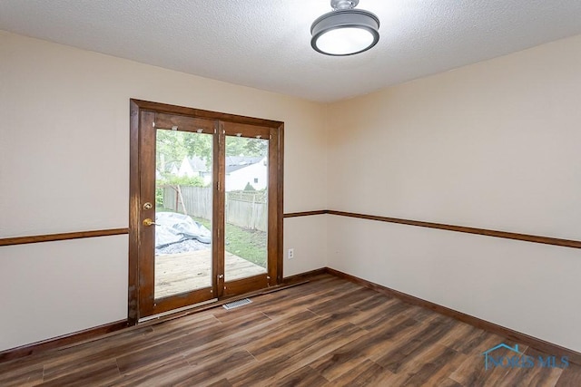 716 Maple St, Perrysburg, OH 43551 - spare room with dark wood-type flooring and a textured ceiling