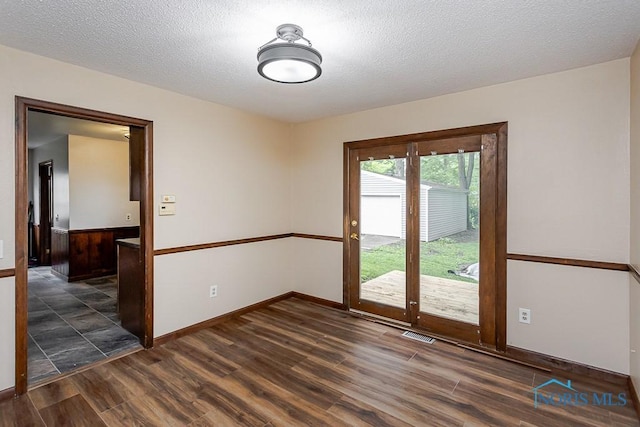 716 Maple St, Perrysburg, OH 43551 - spare room with dark wood finished floors and a textured ceiling