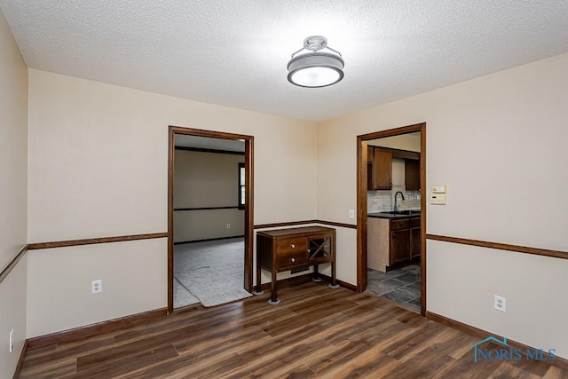 716 Maple St, Perrysburg, OH 43551 - empty room with dark wood finished floors and a textured ceiling