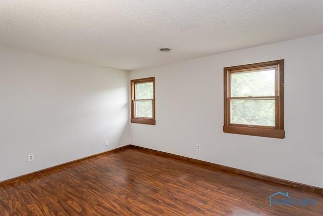 716 Maple St, Perrysburg, OH 43551 - unfurnished room featuring dark wood-type flooring and a textured ceiling