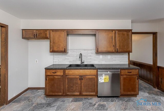716 Maple St, Perrysburg, OH 43551 - kitchen featuring stainless steel dishwasher, stone tile floors, decorative backsplash, and a wainscoted wall