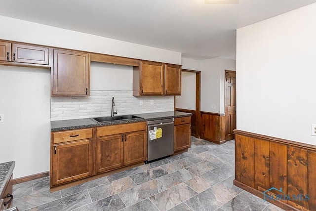 716 Maple St, Perrysburg, OH 43551 - kitchen with stainless steel dishwasher, dark countertops, a wainscoted wall, wood walls, and dark stone finish floors
