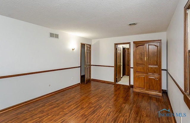 716 Maple St, Perrysburg, OH 43551 - empty room with dark wood finished floors and a textured ceiling