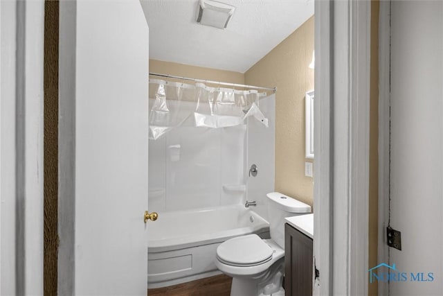 902 Coventry Ave, Toledo, OH 43607 - bathroom featuring toilet, shower / washtub combination, a textured wall, vanity, and wood finished floors