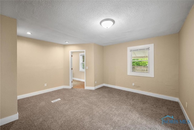 902 Coventry Ave, Toledo, OH 43607 - empty room with carpet floors, a textured ceiling, baseboards, and recessed lighting