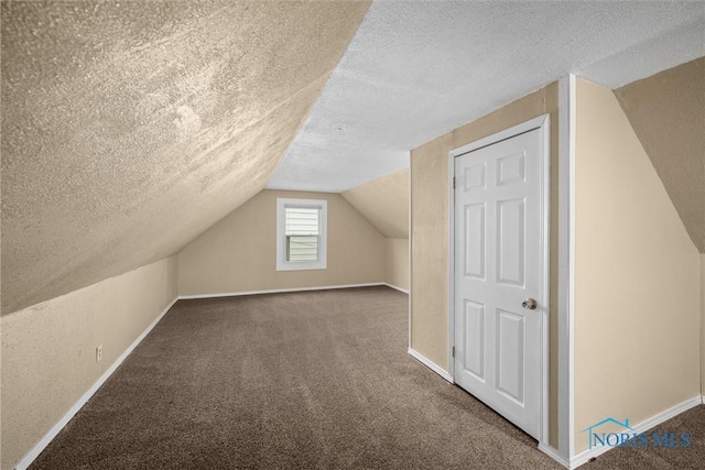 902 Coventry Ave, Toledo, OH 43607 - bonus room featuring a textured ceiling, vaulted ceiling, carpet flooring, and baseboards