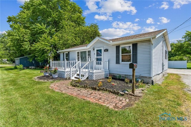 304 Wise St, Forest, OH 45843 - manufactured / mobile home featuring a front lawn and a wooden deck