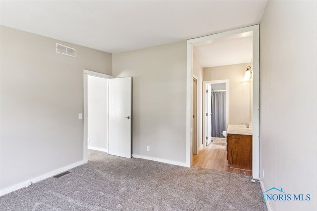 304 Wise St, Forest, OH 45843 - unfurnished bedroom featuring carpet floors and baseboards