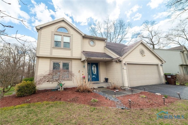 6975 Ramblehurst Rd, Sylvania, OH 43560 - traditional home featuring a garage, driveway, and a front yard