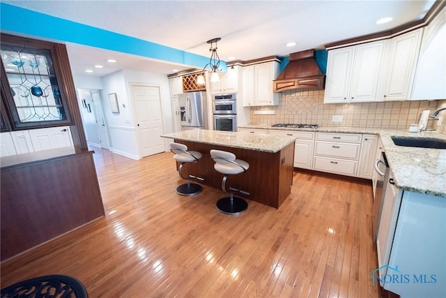 6975 Ramblehurst Rd, Sylvania, OH 43560 - kitchen featuring custom range hood, stainless steel appliances, a center island, backsplash, and pendant lighting