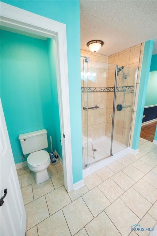 6975 Ramblehurst Rd, Sylvania, OH 43560 - bathroom featuring a shower stall, tile patterned floors, and a textured ceiling