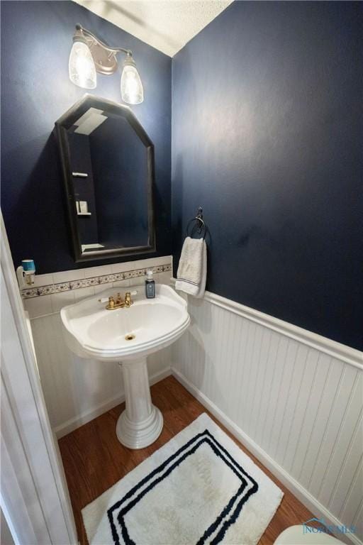 6975 Ramblehurst Rd, Sylvania, OH 43560 - bathroom with wood finished floors and a wainscoted wall