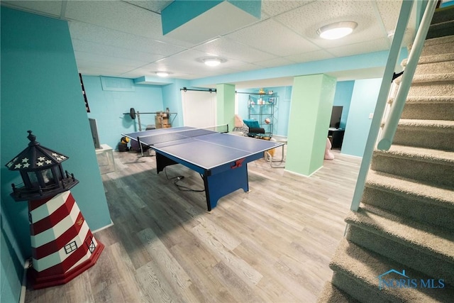 6975 Ramblehurst Rd, Sylvania, OH 43560 - recreation room featuring a paneled ceiling, wood finished floors, and concrete block wall