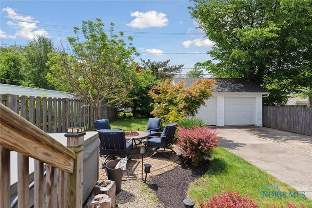 2707 Gunckel Blvd, Toledo, OH 43606 - view of yard with an outdoor structure, a garage, and an outdoor fire pit