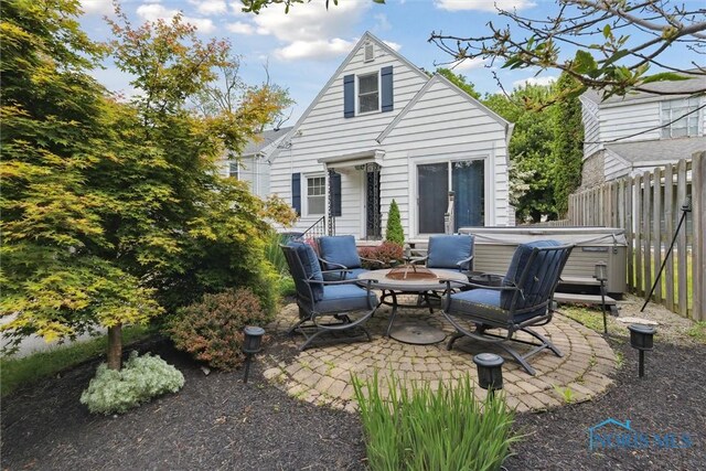2707 Gunckel Blvd, Toledo, OH 43606 - back of property featuring a hot tub and a patio area