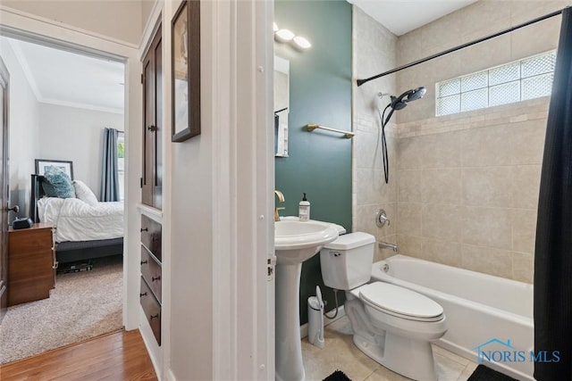 2707 Gunckel Blvd, Toledo, OH 43606 - ensuite bathroom featuring shower / bath combo with shower curtain, ornamental molding, and wood finished floors