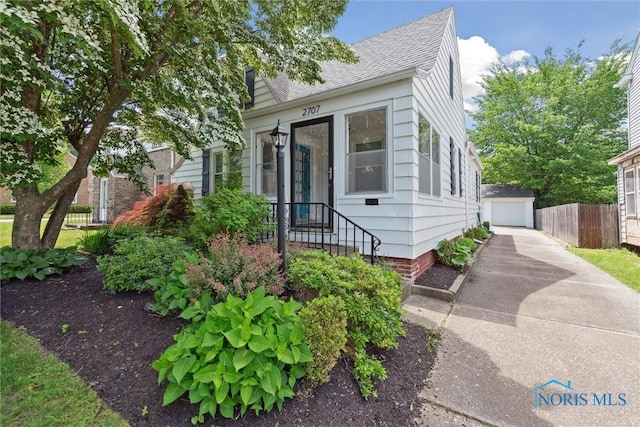2707 Gunckel Blvd, Toledo, OH 43606 - view of front of home featuring an outbuilding, roof with shingles, and a garage