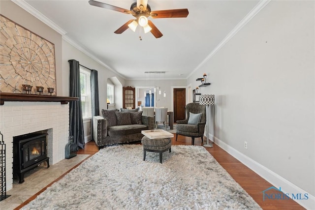 2707 Gunckel Blvd, Toledo, OH 43606 - living room featuring crown molding, ceiling fan, wood finished floors, and a brick fireplace