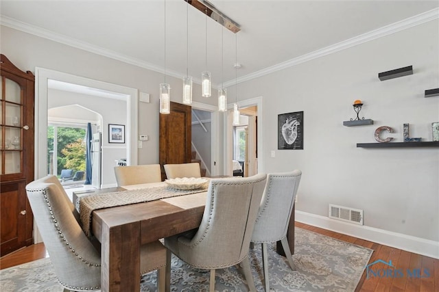 2707 Gunckel Blvd, Toledo, OH 43606 - dining space featuring wood-type flooring, stairway, and ornamental molding