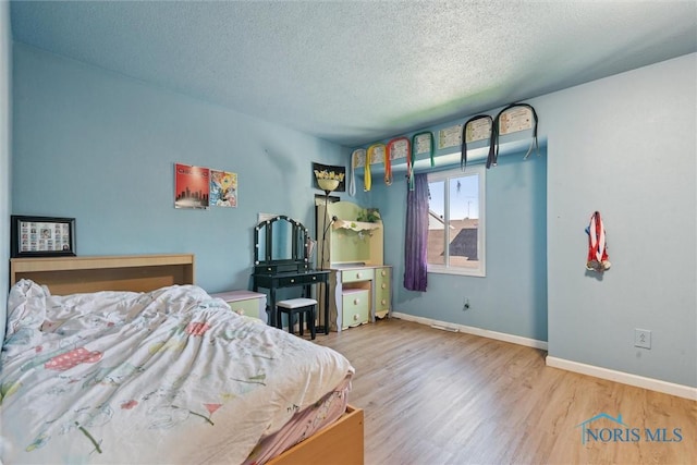 2540 Plum Leaf Ln, Toledo, OH 43614 - bedroom with a textured ceiling and wood finished floors