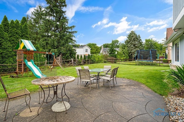 2709 Derby Rd, Ottawa Hills, OH 43615 - fenced backyard featuring a trampoline, a patio, a playground, and outdoor dining area