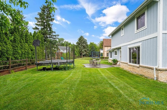 2709 Derby Rd, Ottawa Hills, OH 43615 - fenced yard featuring a trampoline and a patio