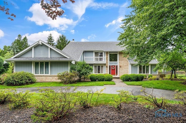 2709 Derby Rd, Ottawa Hills, OH 43615 - view of front facade with brick siding, a front lawn, and a shingled roof