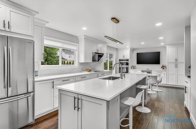 2709 Derby Rd, Ottawa Hills, OH 43615 - kitchen featuring appliances with stainless steel finishes, a kitchen island with sink, white cabinetry, and recessed lighting