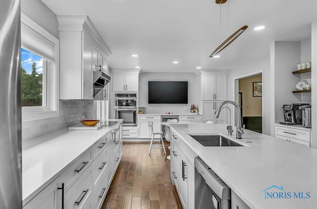 2709 Derby Rd, Ottawa Hills, OH 43615 - kitchen with appliances with stainless steel finishes, light countertops, dark wood-type flooring, white cabinetry, and recessed lighting