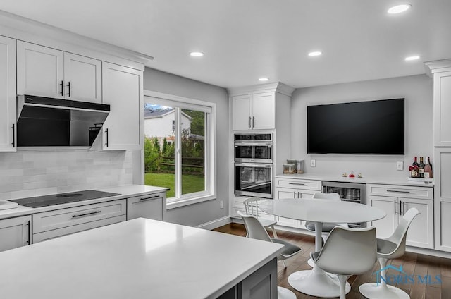 2709 Derby Rd, Ottawa Hills, OH 43615 - kitchen with black electric stovetop, stainless steel double oven, light countertops, and recessed lighting