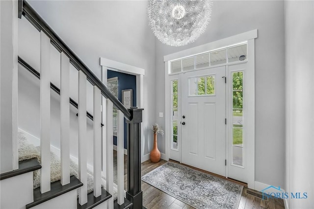 9211 Stable Creek Ct, Sylvania, OH 43560 - foyer entrance featuring stairway, a chandelier, and wood finished floors
