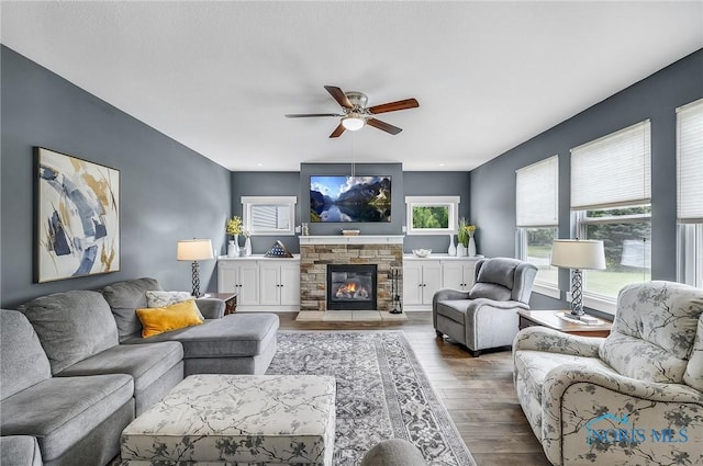 9211 Stable Creek Ct, Sylvania, OH 43560 - living area with ceiling fan, wood finished floors, and a stone fireplace