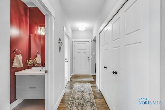 9211 Stable Creek Ct, Sylvania, OH 43560 - hallway with wood finished floors and a sink