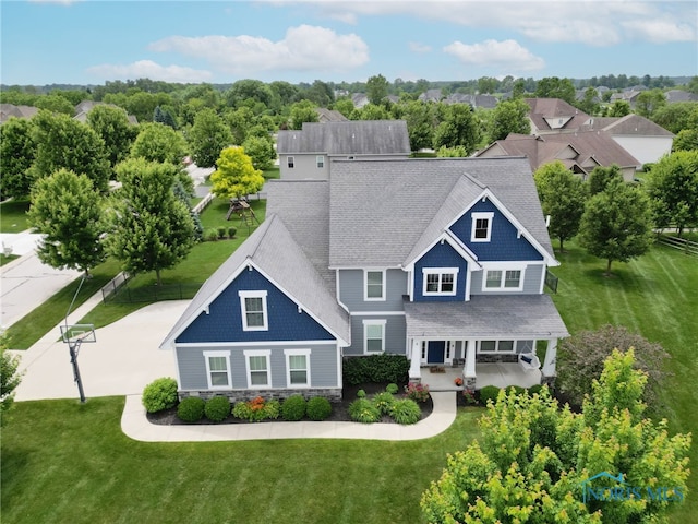 9211 Stable Creek Ct, Sylvania, OH 43560 - view of front of home featuring covered porch, stone siding, and view of wooded area