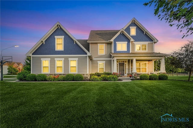 9211 Stable Creek Ct, Sylvania, OH 43560 - view of front of house featuring a front yard, a porch, and stone siding