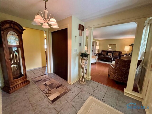 6312 Meadowlark Ln, Payne, OH 45880 - entrance foyer with ornate columns, tile patterned floors, and a chandelier