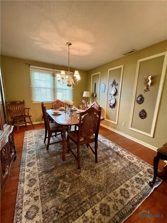 6312 Meadowlark Ln, Payne, OH 45880 - dining room with a chandelier and dark wood-style floors