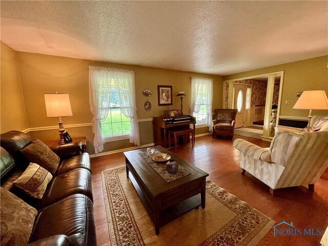 6312 Meadowlark Ln, Payne, OH 45880 - living room with a textured ceiling, plenty of natural light, and wood finished floors