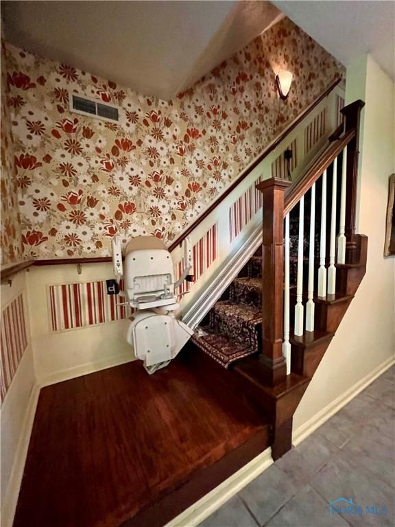 6312 Meadowlark Ln, Payne, OH 45880 - stairs with wallpapered walls, wainscoting, and tile patterned floors