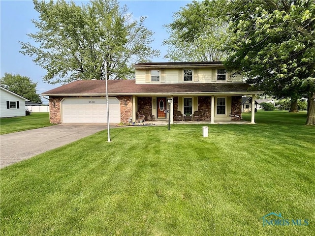 6312 Meadowlark Ln, Payne, OH 45880 - view of front of home featuring a porch, an attached garage, stone siding, a front yard, and driveway