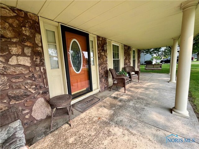 6312 Meadowlark Ln, Payne, OH 45880 - doorway to property featuring covered porch and stone siding