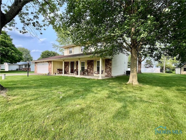 6312 Meadowlark Ln, Payne, OH 45880 - view of front of property with an attached garage, stone siding, and a front lawn