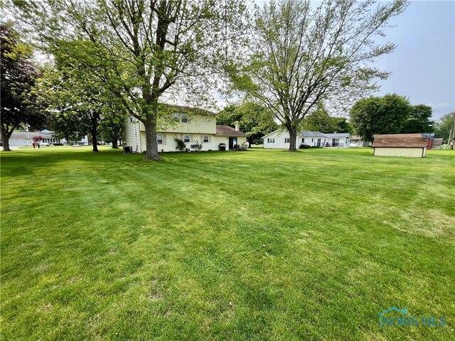 6312 Meadowlark Ln, Payne, OH 45880 - view of green lawn with a shed