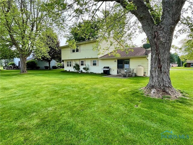 6312 Meadowlark Ln, Payne, OH 45880 - back of house featuring a lawn and a patio area
