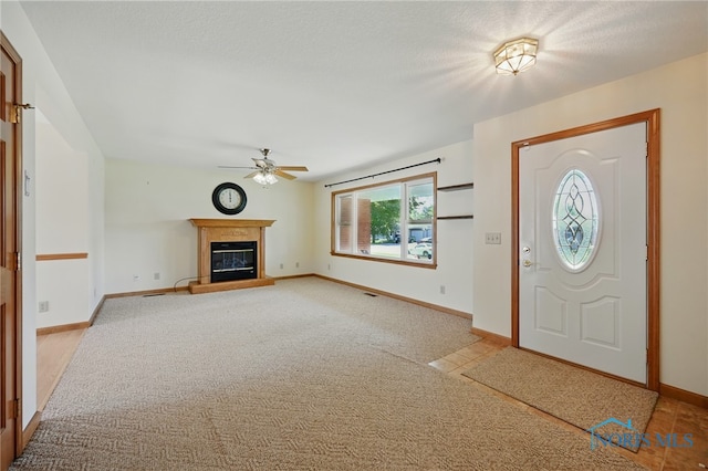 642 Edith Ave, Findlay, OH 45840 - entryway featuring ceiling fan, a glass covered fireplace, and light colored carpet