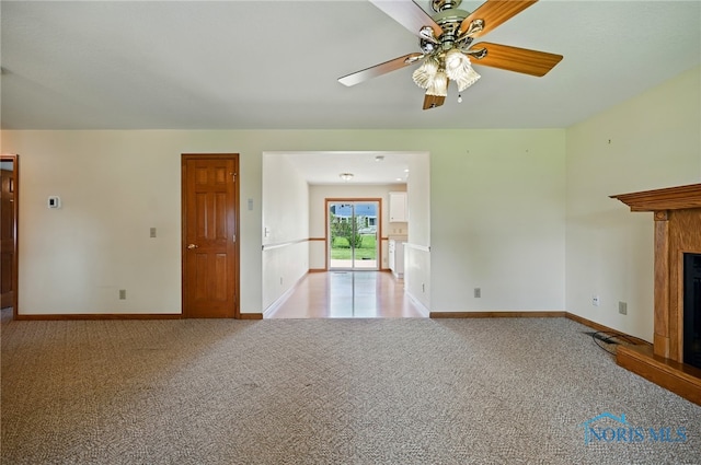 642 Edith Ave, Findlay, OH 45840 - unfurnished living room featuring light carpet, a fireplace with raised hearth, and a ceiling fan