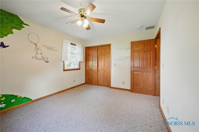642 Edith Ave, Findlay, OH 45840 - unfurnished bedroom with light colored carpet, a ceiling fan, and a closet