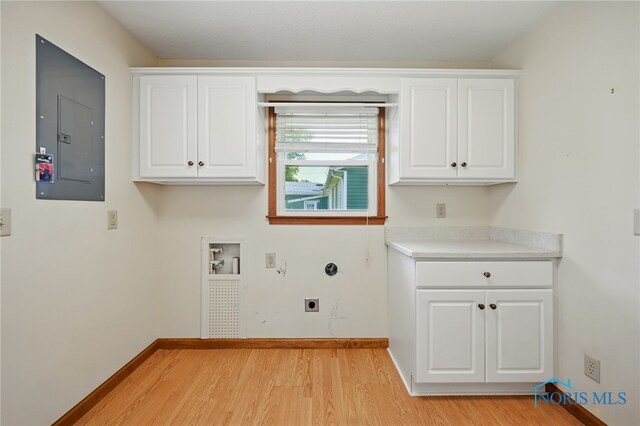 642 Edith Ave, Findlay, OH 45840 - laundry room featuring electric panel, cabinet space, light wood-type flooring, hookup for an electric dryer, and washer hookup