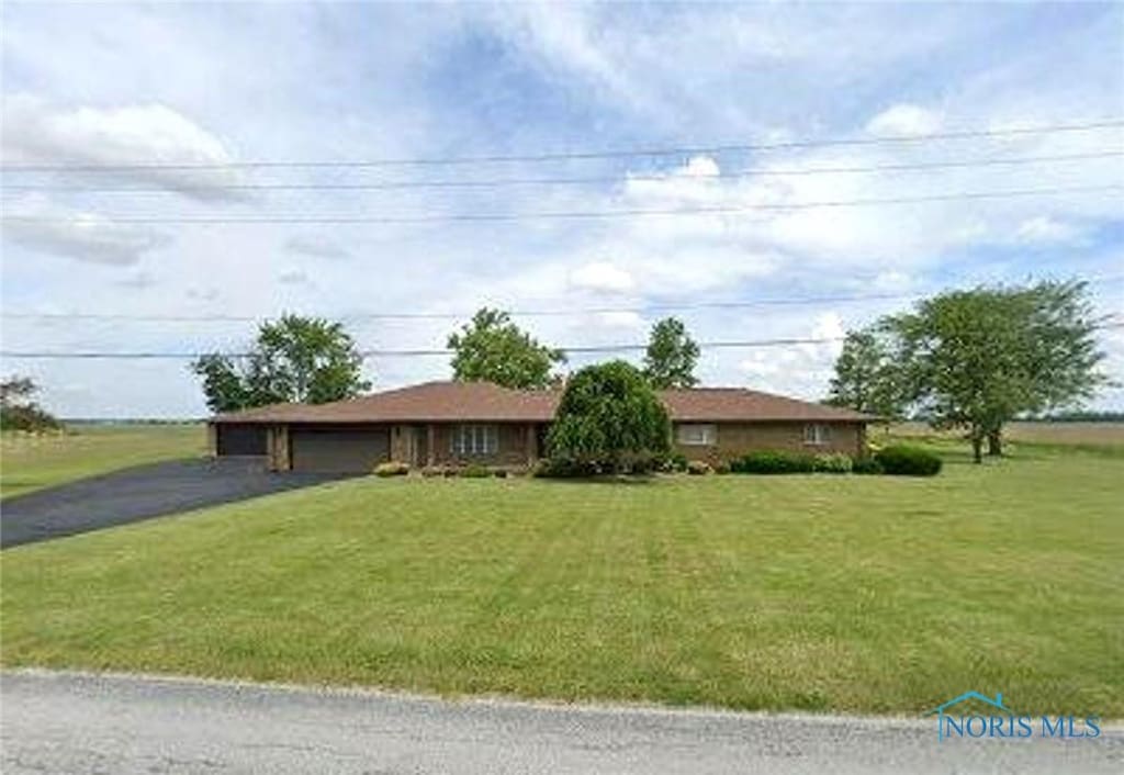 23026 Mermill Rd, Custar, OH 43511 - ranch-style home featuring an attached garage, asphalt driveway, and a front lawn