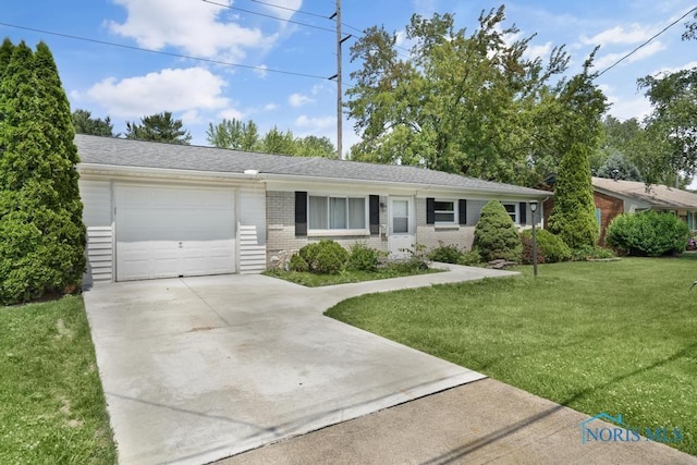 5022 Stengel Ave, Toledo, OH 43614 - single story home with driveway, an attached garage, brick siding, and a front yard